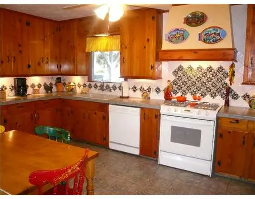 a kitchen with stainless steel appliances a stove a sink and a refrigerator