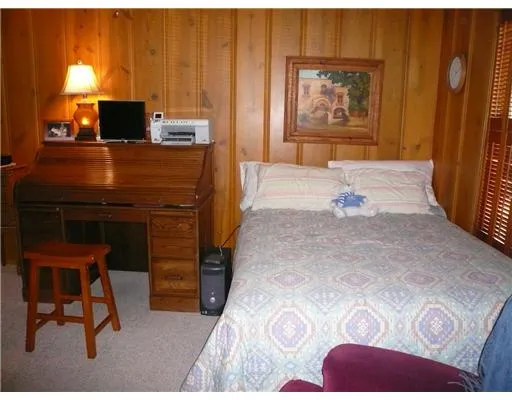 a bedroom with a bed and a television