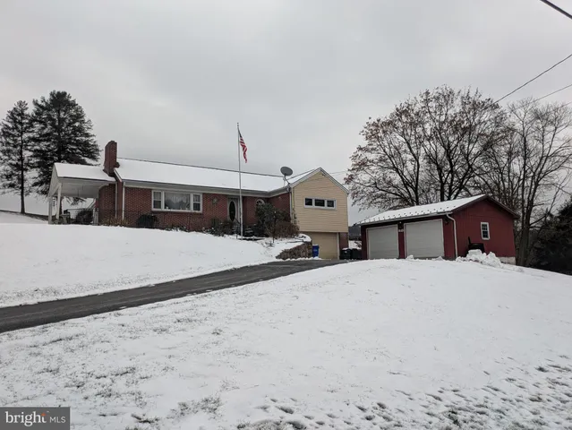 a view of a house with a snow in the background