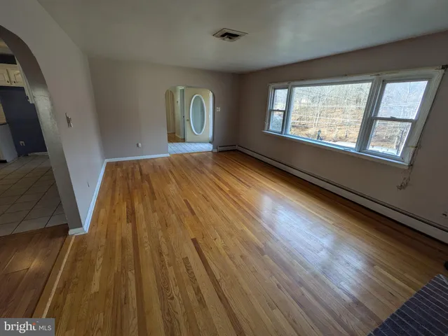 a view of an empty room and glass door