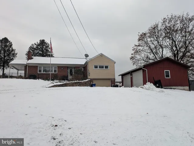 a front view of house with a yard and garage