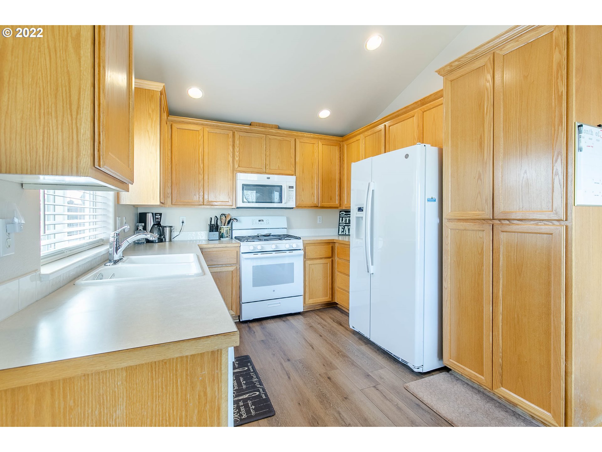6073 Pine Ridge Place Eugene, OR 97402 - Photo 8 of 18 a kitchen with a refrigerator a sink and cabinets