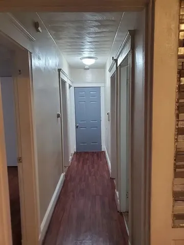 a view of hallway with wooden floor