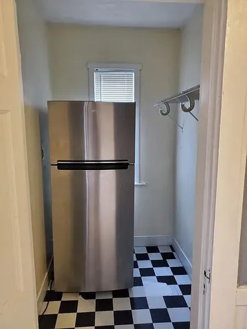 a black and white wall in a kitchen with a refrigerator