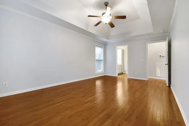 a view of an empty room with wooden floor