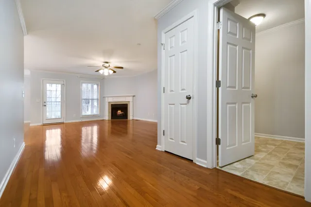 a view of a livingroom with wooden floor and a ceiling fan