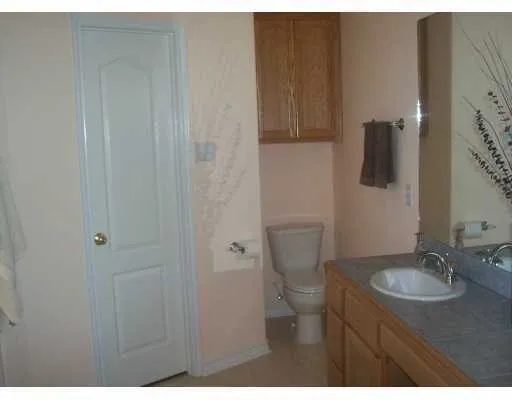 a bathroom with toilet sink and mirror