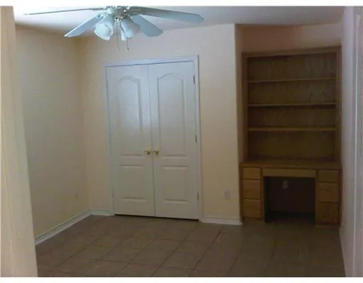 a view of empty room with a fireplace and cabinet