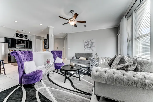 a living room with furniture and kitchen view