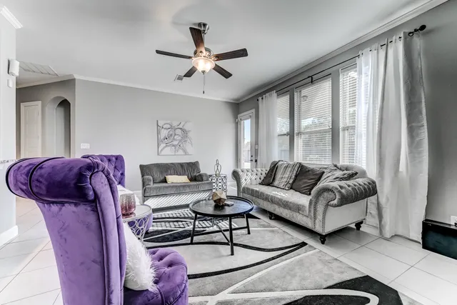 a living room with furniture and a large window