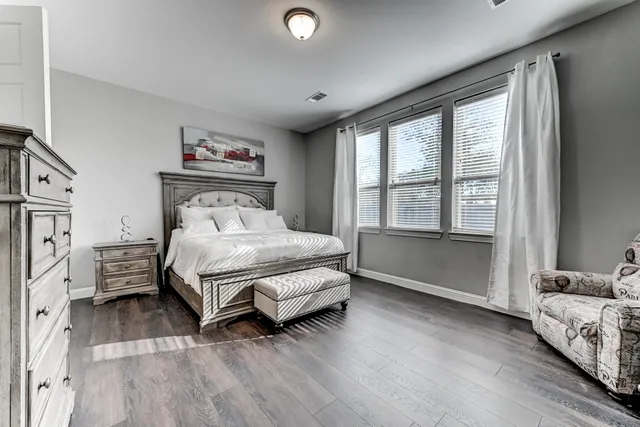 a bedroom with a bed and a large window