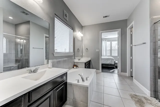 a bathroom with a sink double vanity and a mirror