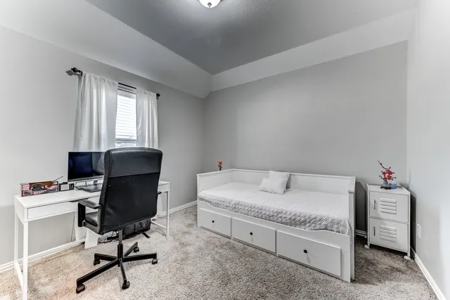 a bedroom with a workspace