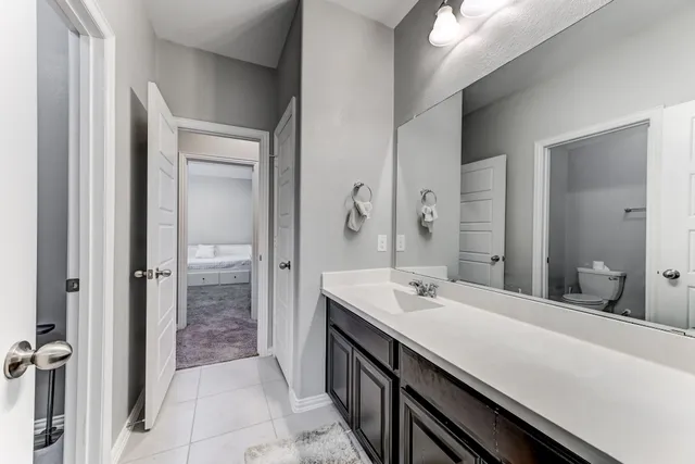 a bathroom with a double vanity sink and mirror