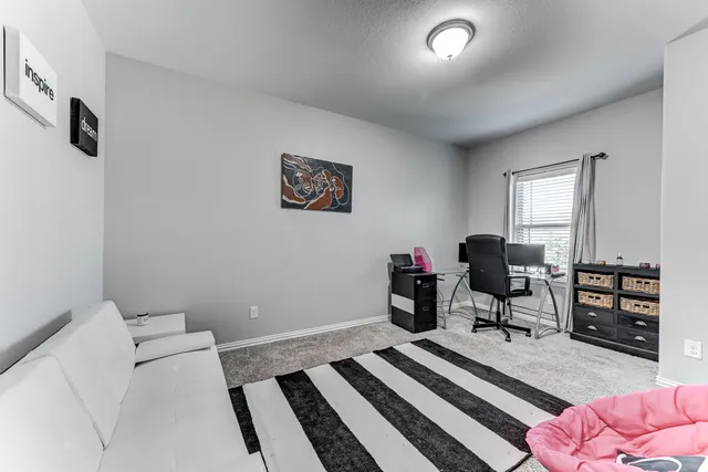 a bedroom with a bed and a desk