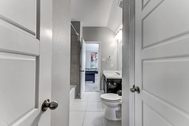 a bathroom with a toilet a sink and shower