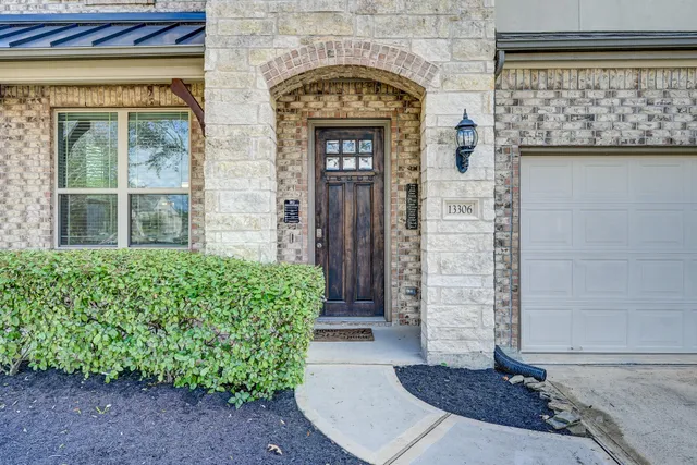 a front view of a house with a garden
