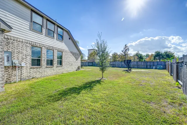 a house view with swimming pool in front of it