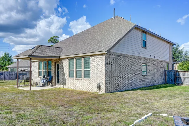 a view of a house with a yard and sitting area