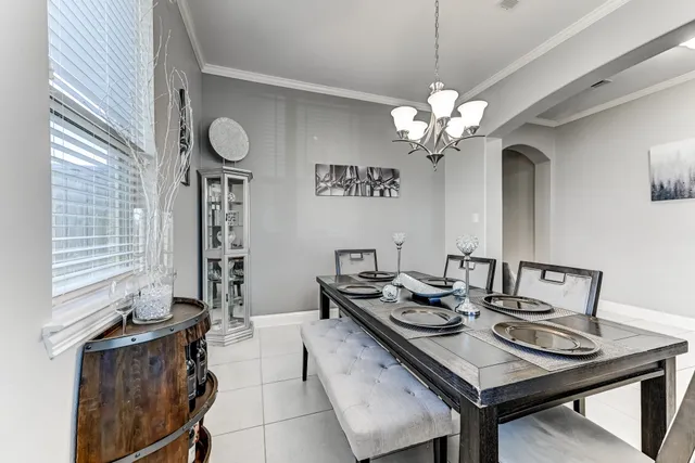 a view of a dining room with furniture and a chandelier
