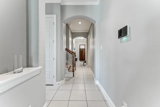 a view of a hallway to a livingroom and a bathroom