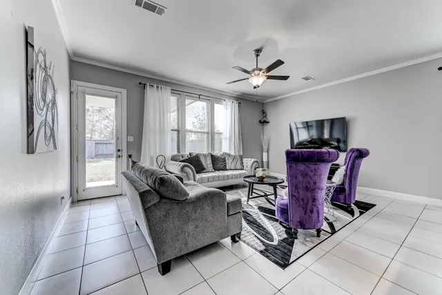 a living room with furniture a chandelier and a piano