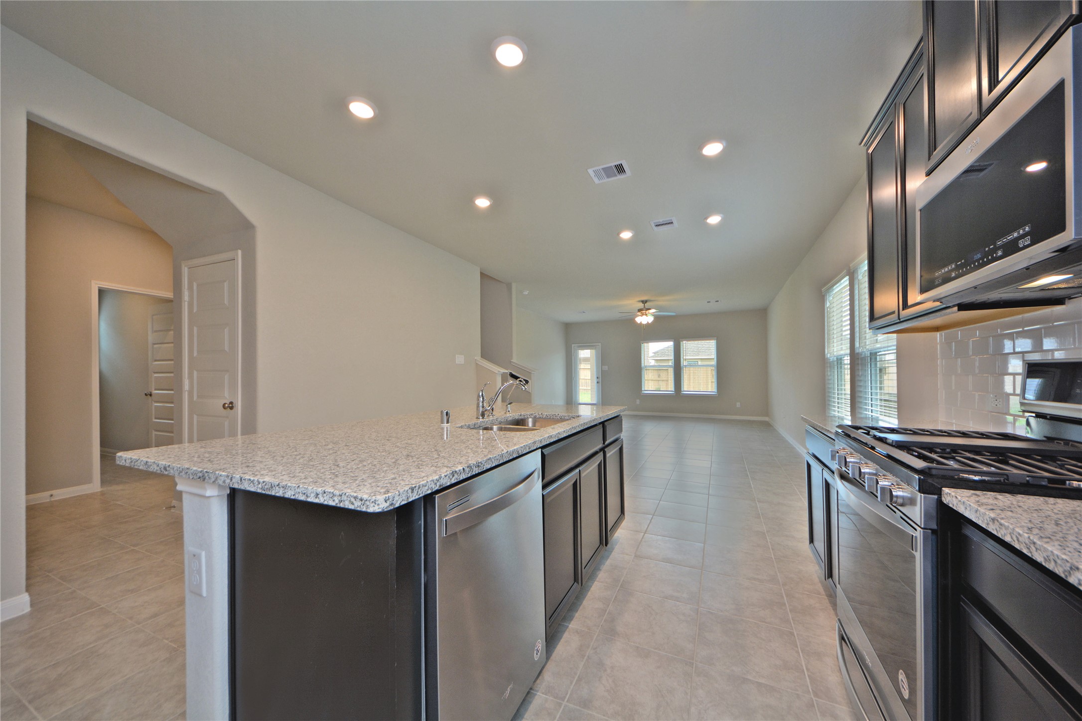 1015 Modesto Drive Rosharon, TX 77583 - Photo 15 of 37 Spacious kitchen with long stretches of countertop space and an open view into the living area, making entertaining effortless! This layout is ideal for hosting family and friends while staying connected.