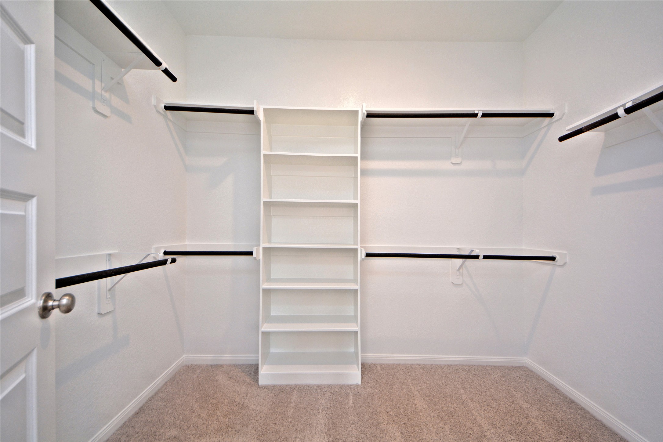 1015 Modesto Drive Rosharon, TX 77583 - Photo 19 of 37 Massive walk-in closet in the primary suite featuring built in shelving and ample hanging space for all your storage needs! Stay organized with ease in this thoughtfully designed closet that truly completes the primary retreat. This is only one side of this massive walk in closet!