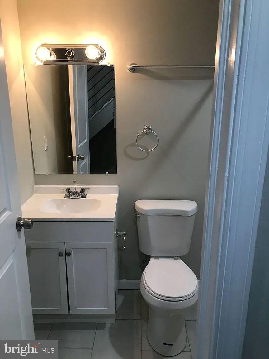 228 South Edgewood Street Philadelphia, PA 19139 - Photo 15 of 15 a bathroom with a sink toilet and mirror