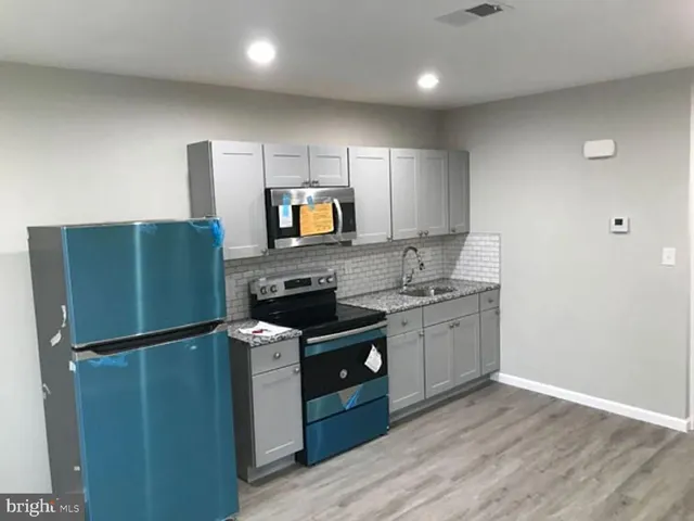 a kitchen with granite countertop stainless steel appliances and wooden cabinets