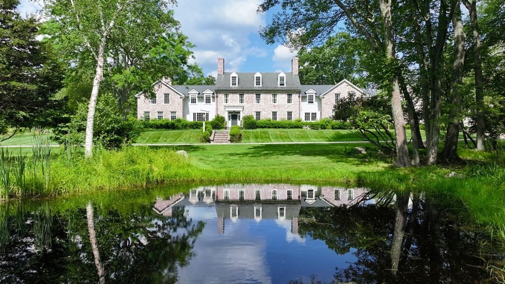 a view of a house with garden and a lake view