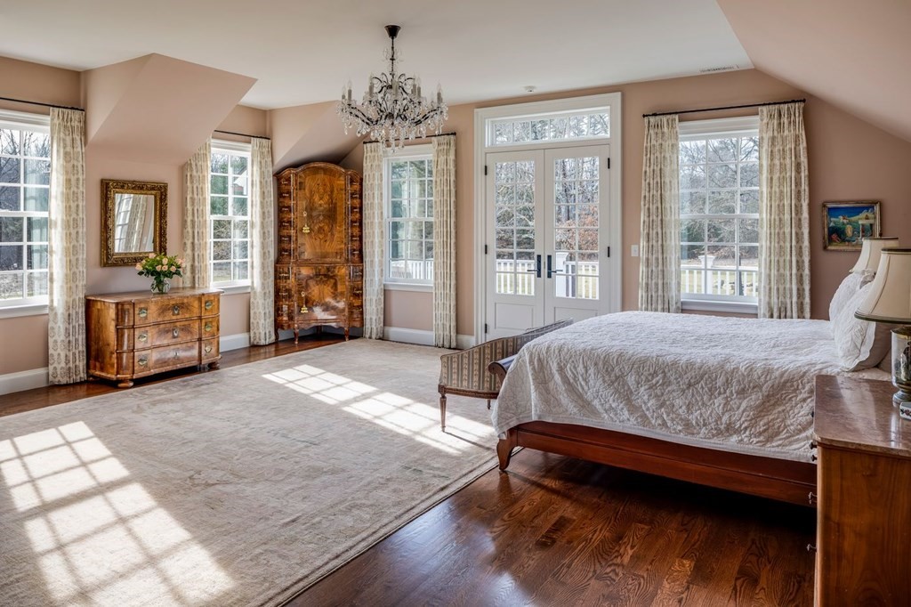 401 Sandy Valley Road Westwood, MA 02090 - Photo 10 of 26 a spacious bedroom with a large bed and a chandelier