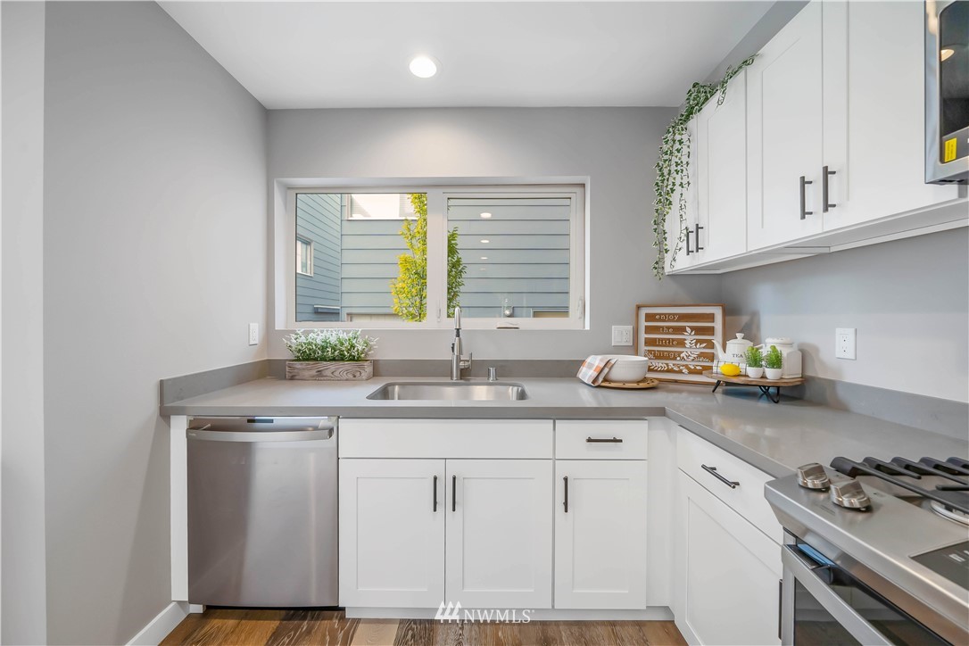 423 Martin Luther King Jr Way South, Unit A Seattle, WA 98144 - Photo 16 of 31 a kitchen with granite countertop a sink a stove and cabinets