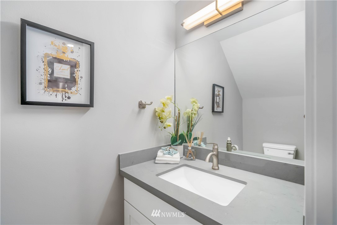 423 Martin Luther King Jr Way South, Unit A Seattle, WA 98144 - Photo 18 of 31 a bathroom with a sink and a mirror