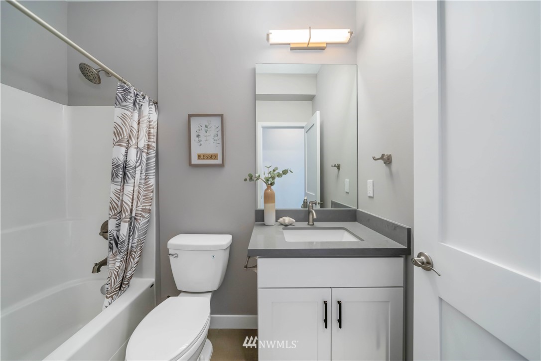 423 Martin Luther King Jr Way South, Unit A Seattle, WA 98144 - Photo 25 of 31 a bathroom with a granite countertop sink toilet and shower