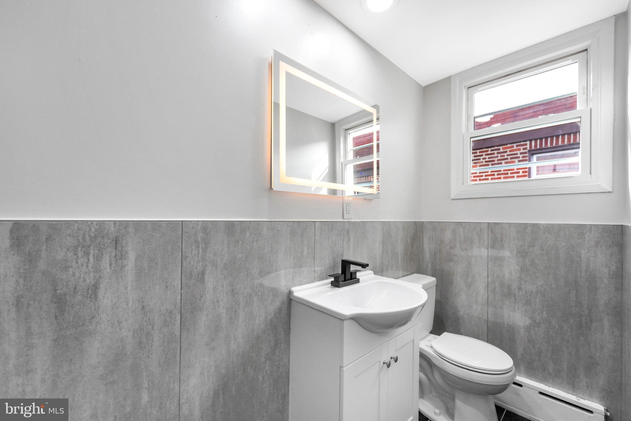 4938 State Road Drexel Hill, PA 19026 - Photo 18 of 38 a bathroom with a sink mirror and toilet