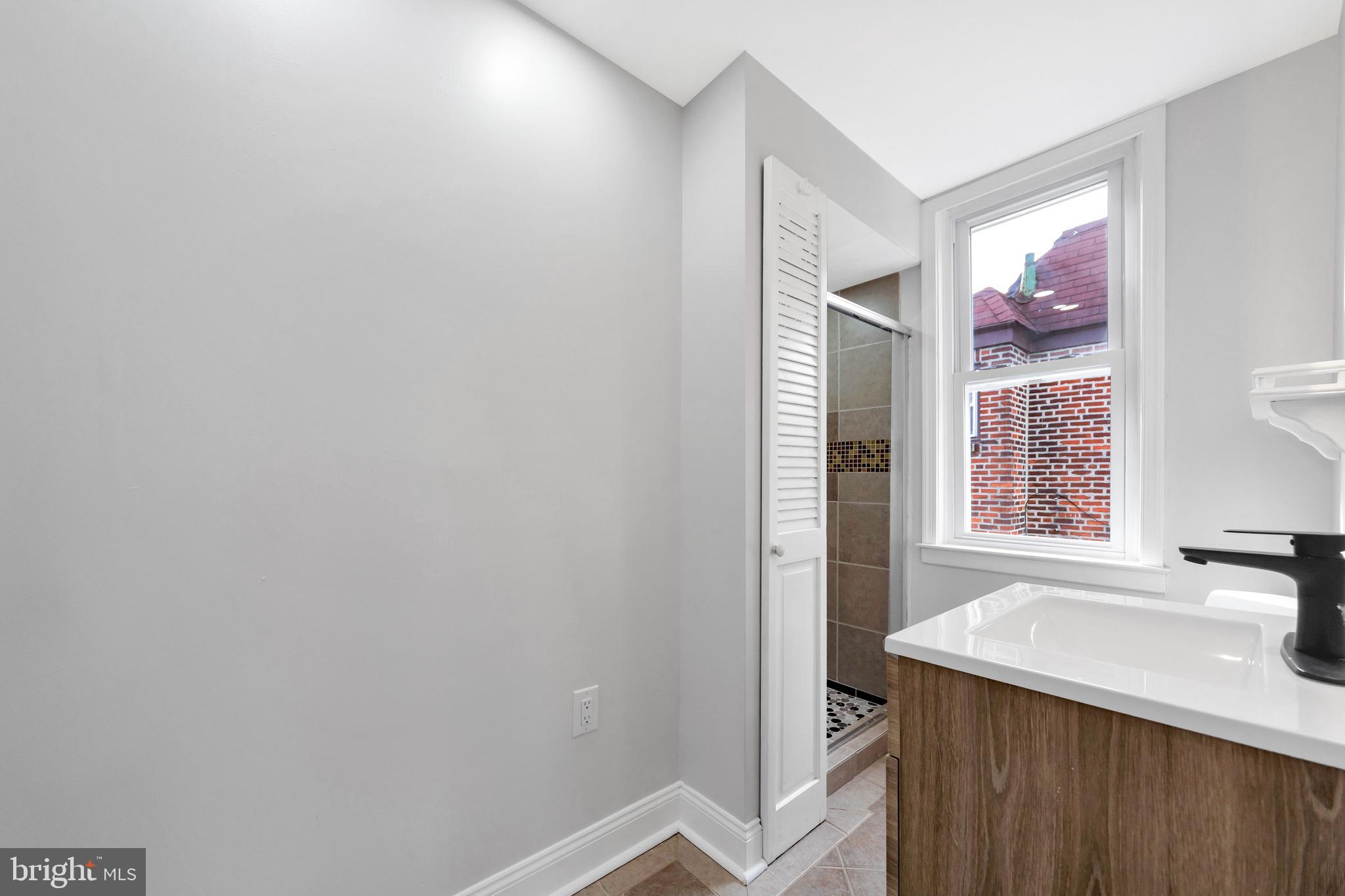 4938 State Road Drexel Hill, PA 19026 - Photo 25 of 38 a bathroom with a sink and a mirror