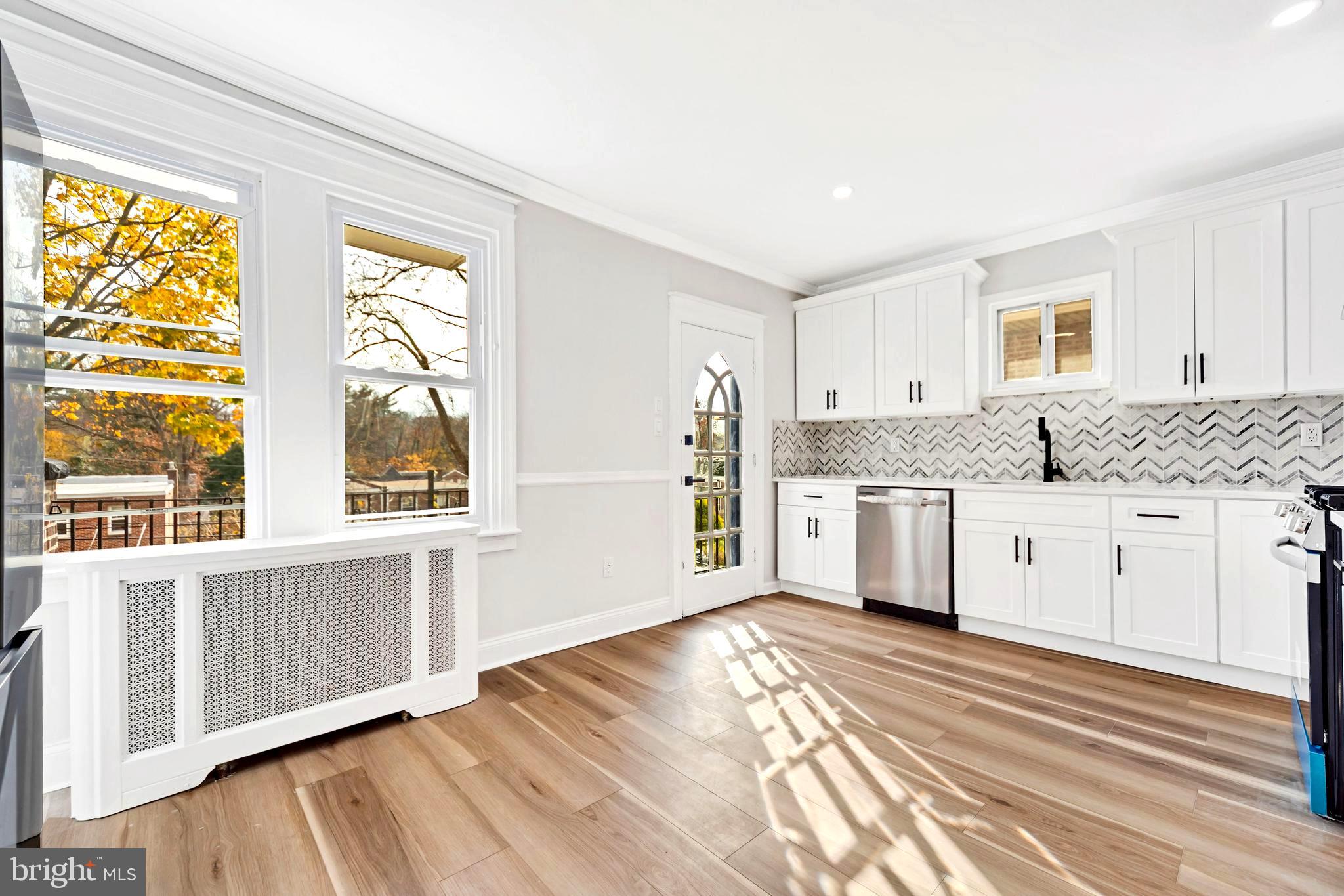 4938 State Road Drexel Hill, PA 19026 - Photo 10 of 38 a kitchen with granite countertop white cabinets and white appliances