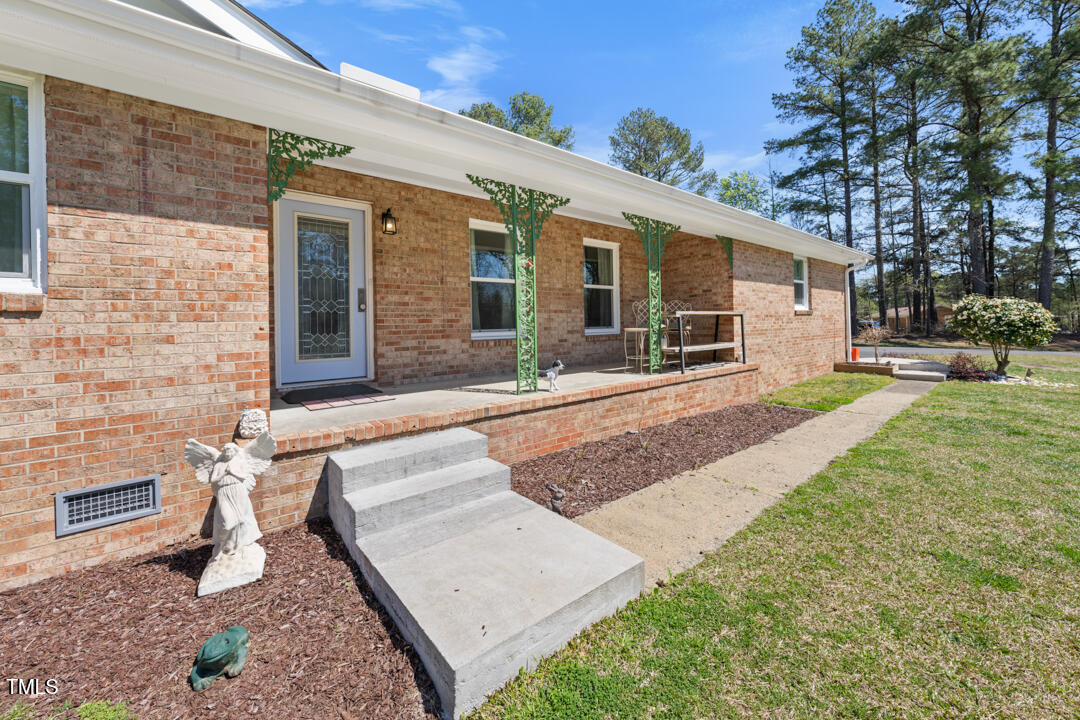 916 Clayton Road Durham, NC 27703 - Photo 21 of 32 a front view of a house with a yard and seating space