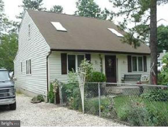 a view of house with backyard