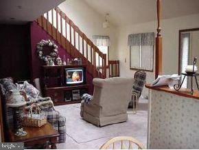 1913 Whitcomb Road Forked River, NJ 08731 - Photo 4 of 6 a living room with furniture a fireplace and a flat screen tv