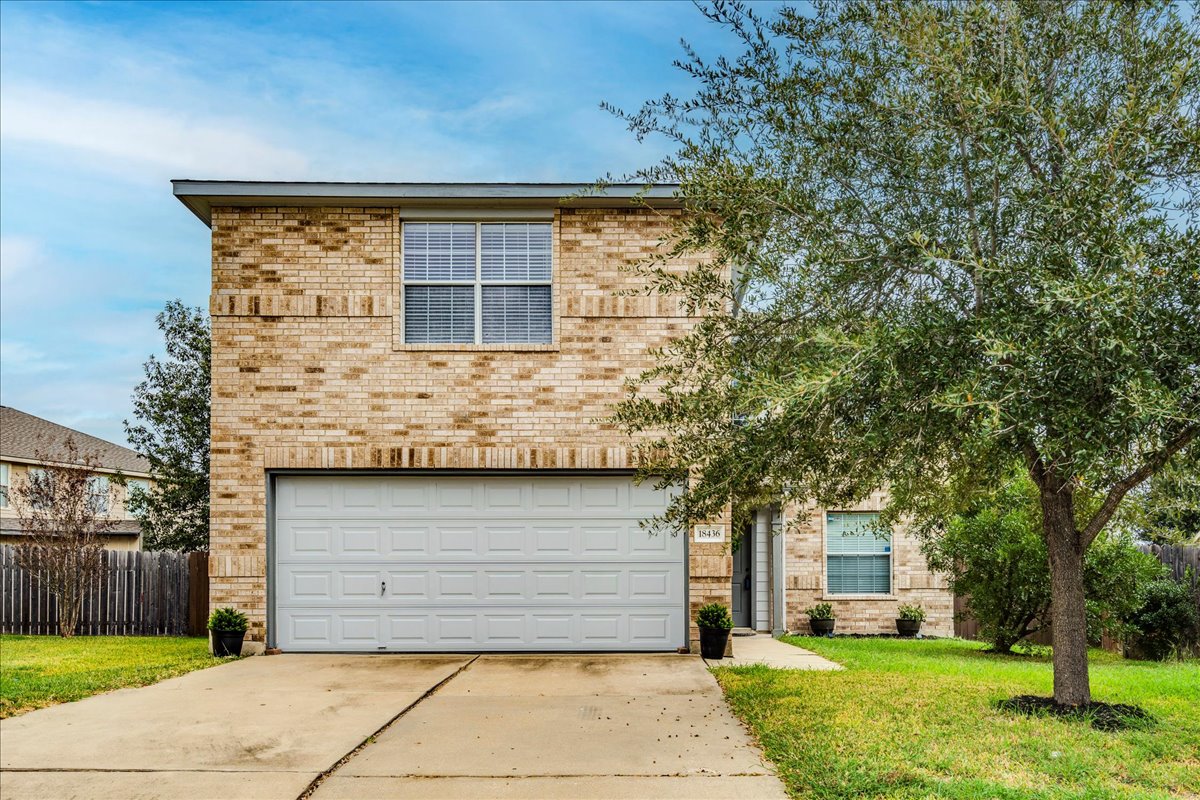 18436 Wind Tree Lane Elgin, TX 78621 - Photo 1 of 1 Curb appeal featuring mature tree and lush landscape