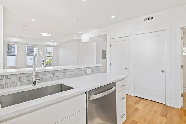 a kitchen with a sink and cabinets