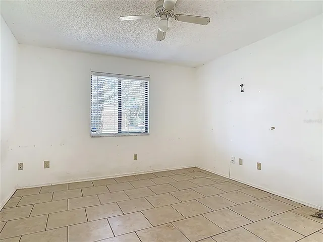 a view of a room with a bed and a window