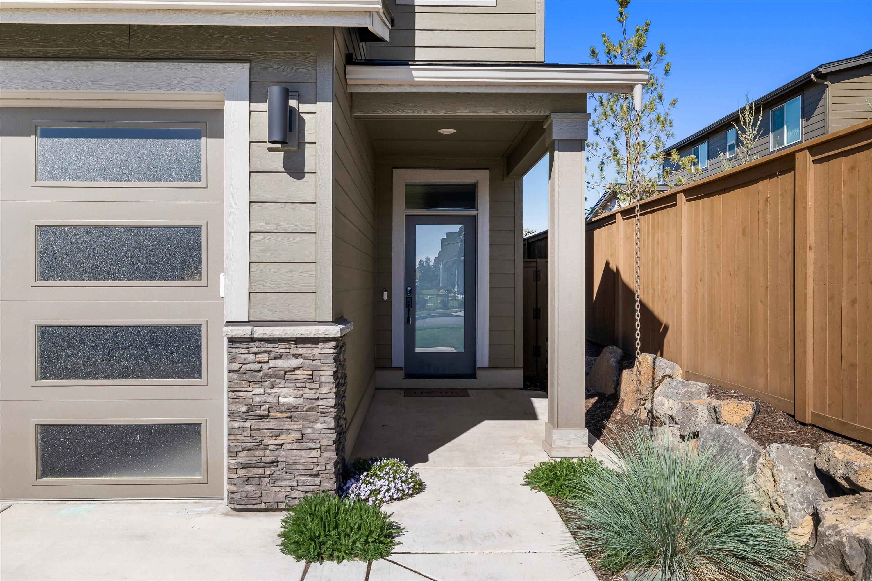60903 Southeast Epic Place Bend, OR 97702 - Photo 6 of 48 a front view of a house with a yard