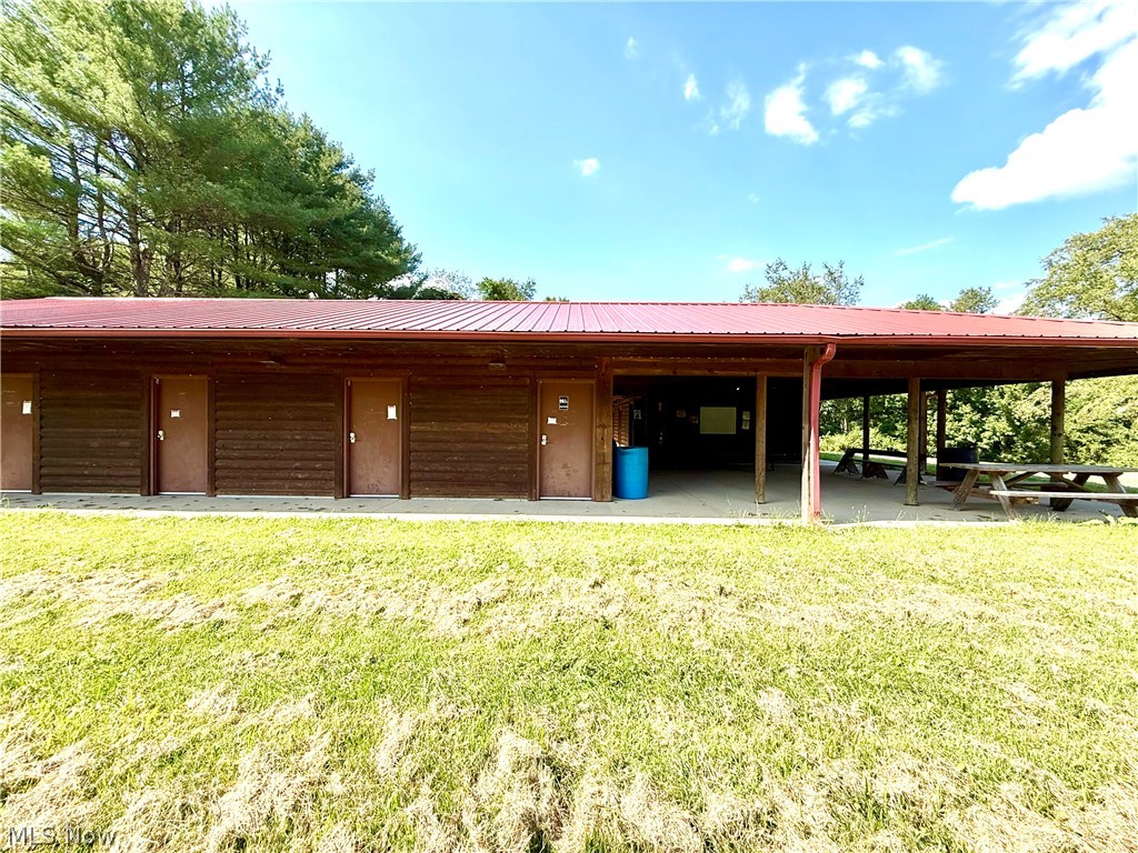 79601 Adams Road Freeport, OH 43973 - Photo 12 of 49 Log bathhouse building with 12 regular full bathrooms and 2 handicapped accessible bathrooms, laundry room and underground bunker. The building features a deck area and tankless water heaters.