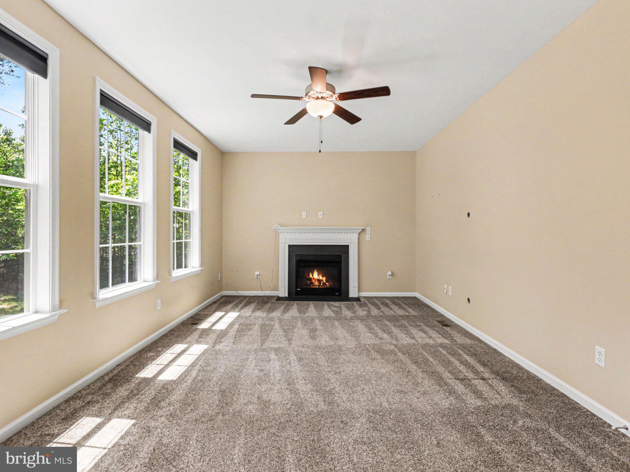 9811 Catharpin Road Spotsylvania, VA 22551 - Photo 5 of 30 a view of an empty room with a fireplace and a window