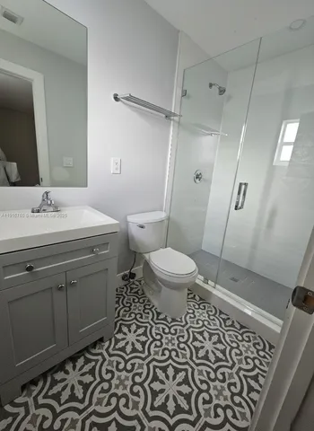 a view of a big house with a big yard and large trees