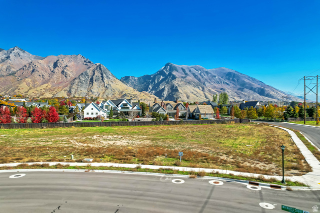 5014 West Jonathon Road American Fork, UT 84003 - Photo 1 of 4 Expansive land parcel featuring a curved asphalt street, concrete sidewalks, and a street light