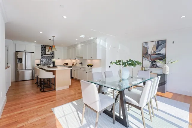a dining room with kitchen island a table and chairs